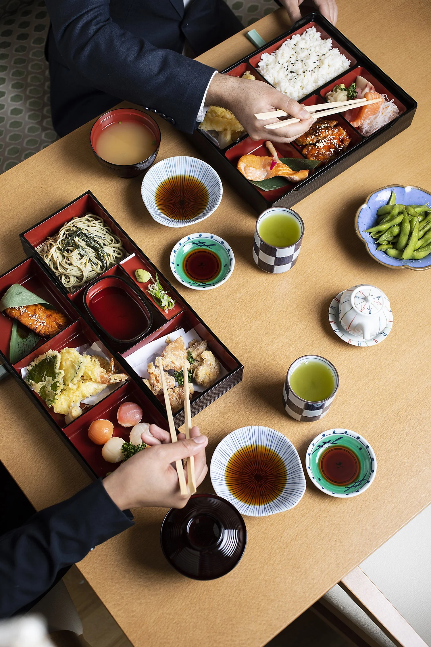Traditional Japanese meal with sushi, tempura, sashimi, noodles, and beverages. Kei Downtown, Food photography in Kuwait