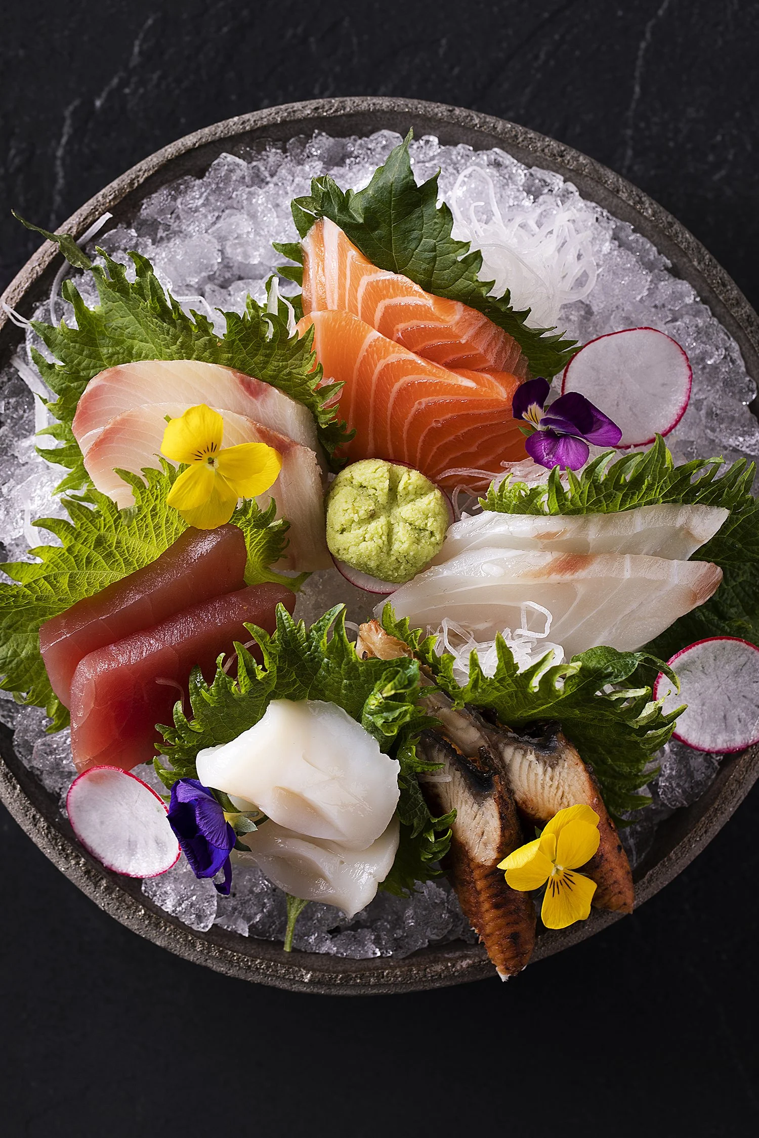 Assorted sashimi platter with slices of tuna, salmon, white fish, and squid on a bed of crushed ice, Sushi shot for Sintoho, Four Seasons
