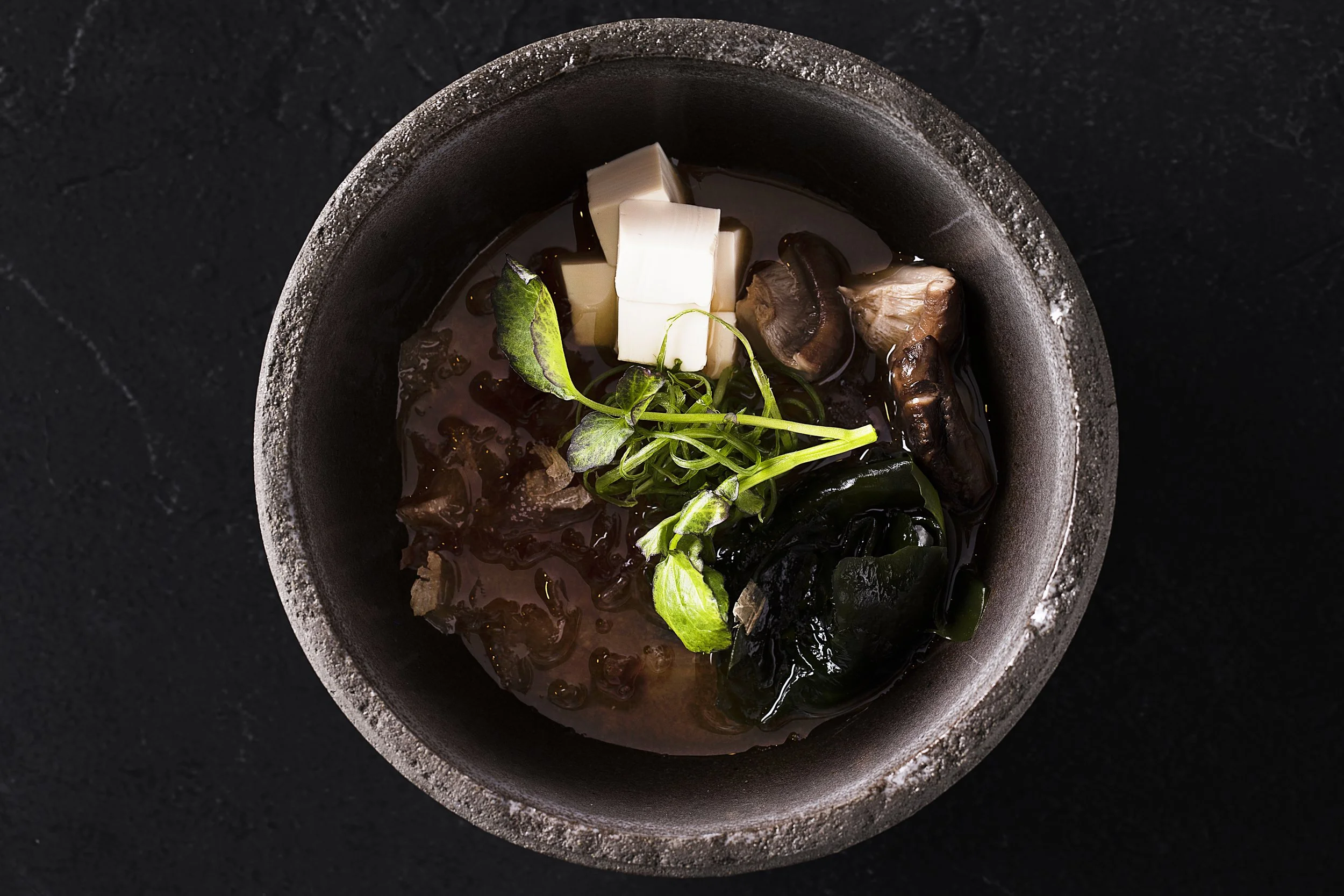 A bowl of hot miso soup with tofu
