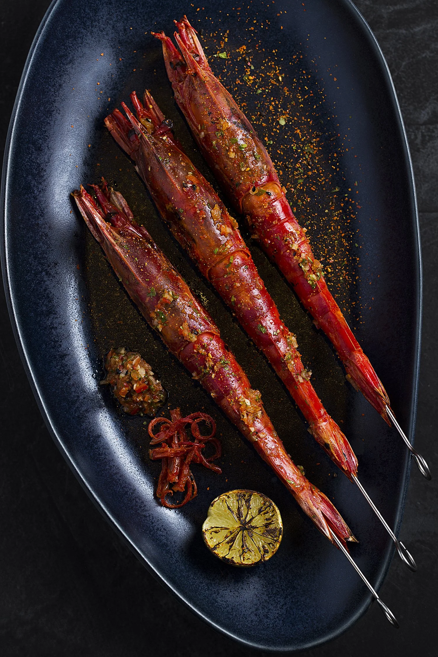Three grilled shrimps on skewers