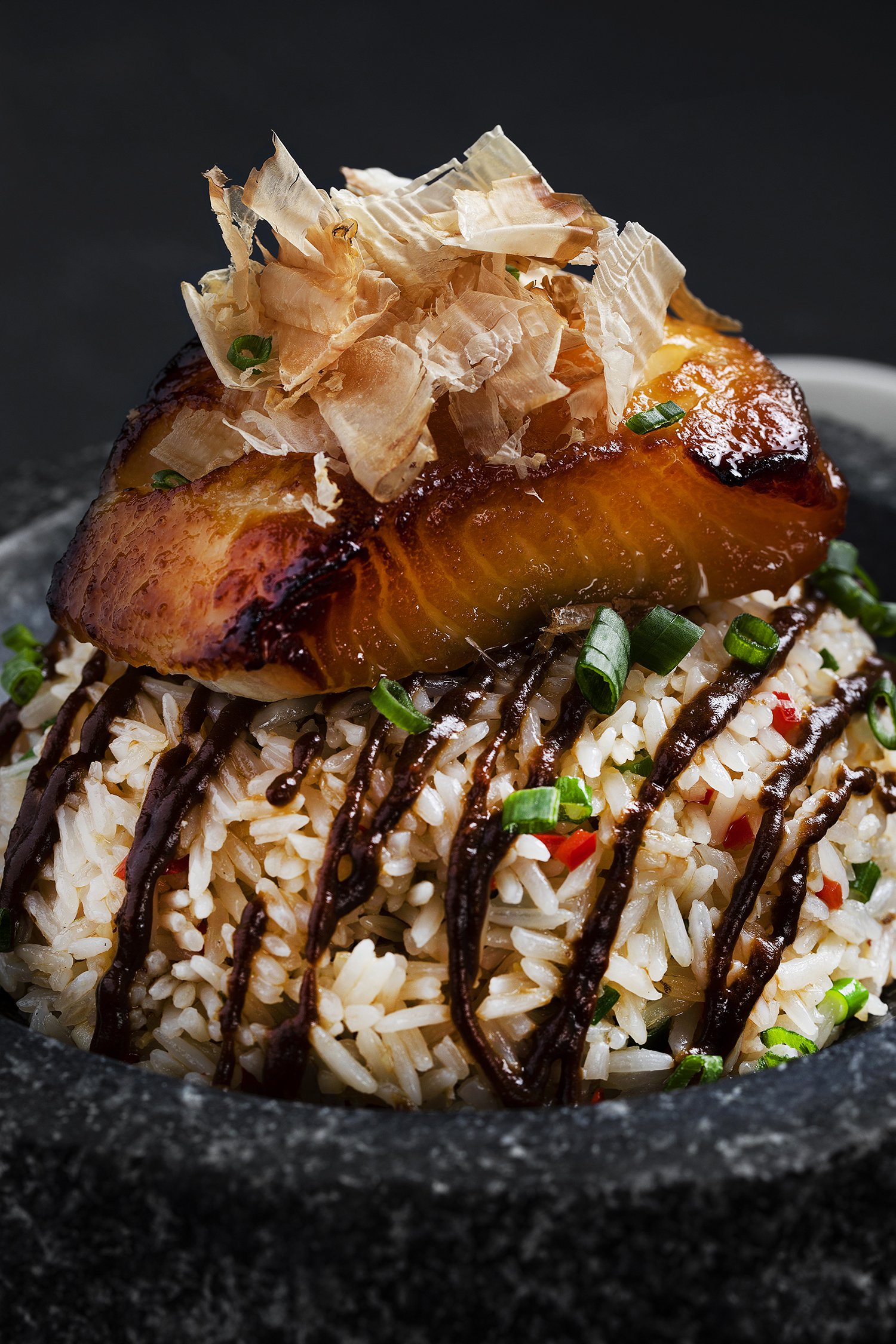Close-up of a bowl of Japanese-style rice topped with grilled salmon