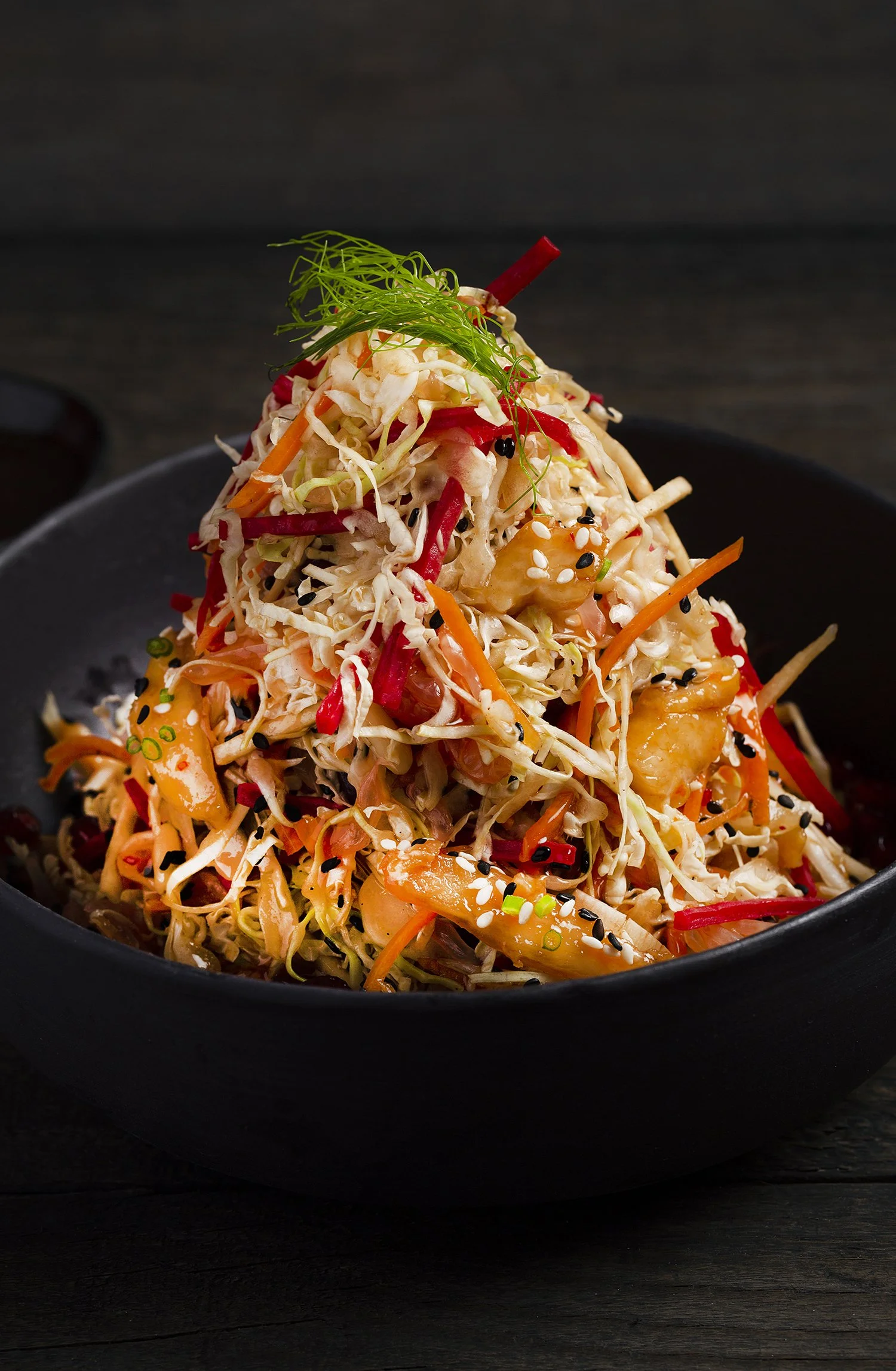 vegetables salad, garnished with green herbs and sesame seeds