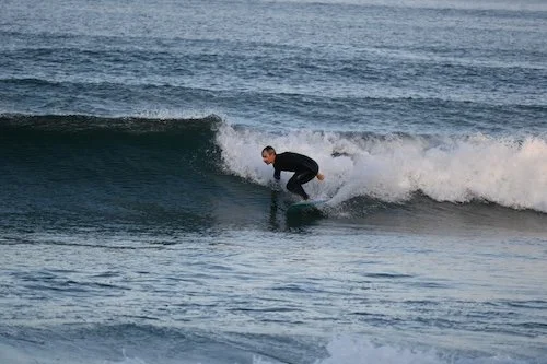 surfer surfing on a blue surfboard