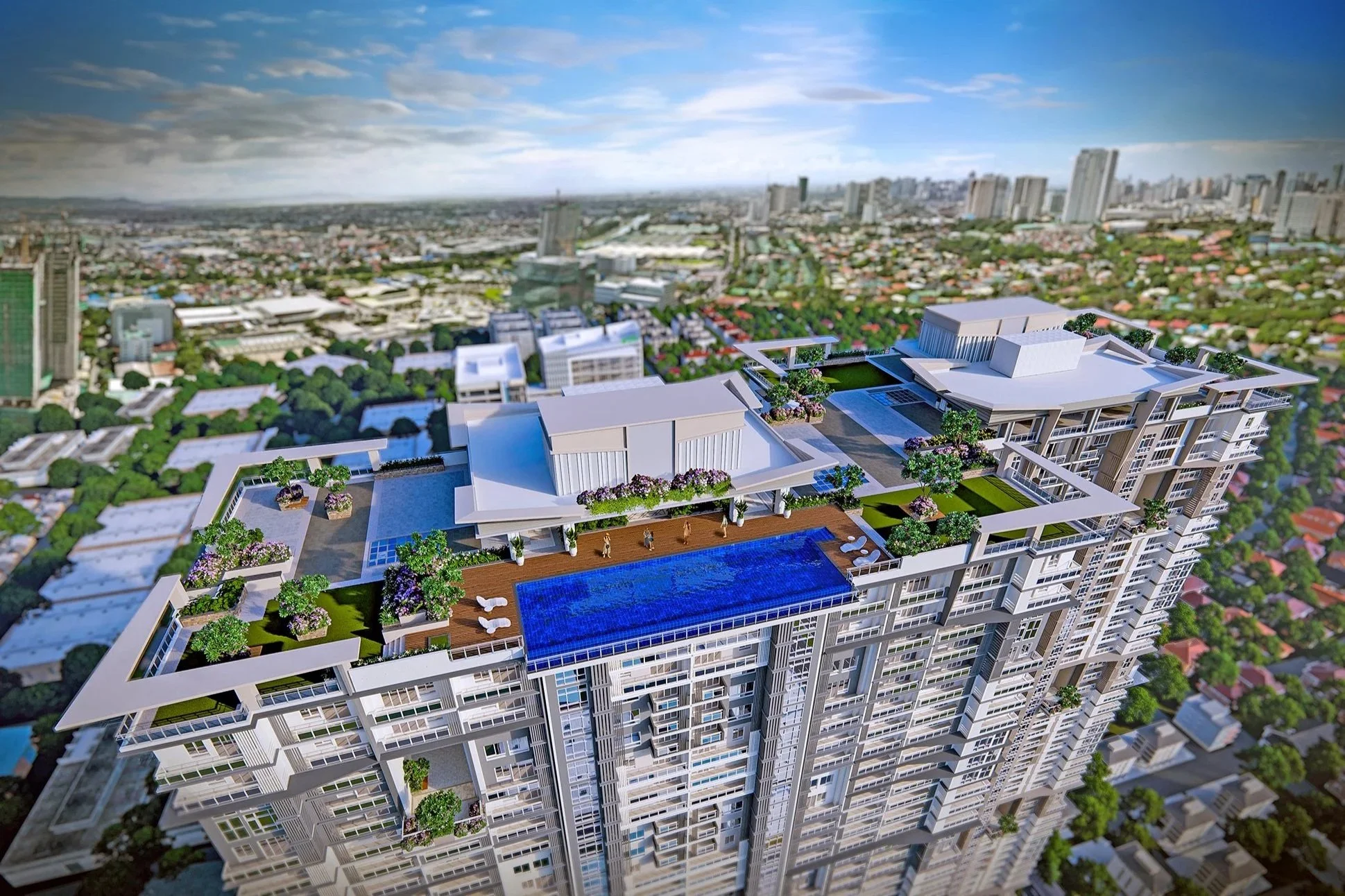 Aerial view of a modern high-rise apartment building with rooftop amenities, including a large swimming pool, lounge chairs, and landscaped gardens, set in an urban area with trees and various buildings in the background.