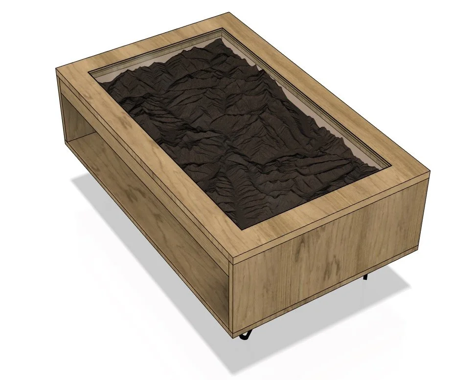 A wooden display case with a glass top, showcasing a detailed 3D topographic map of a mountain range.