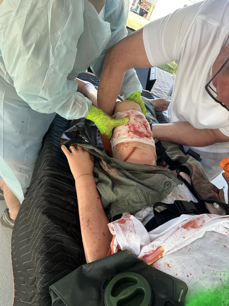 Students packing a wound on a trauma manikin during a Civilian Trauma Course