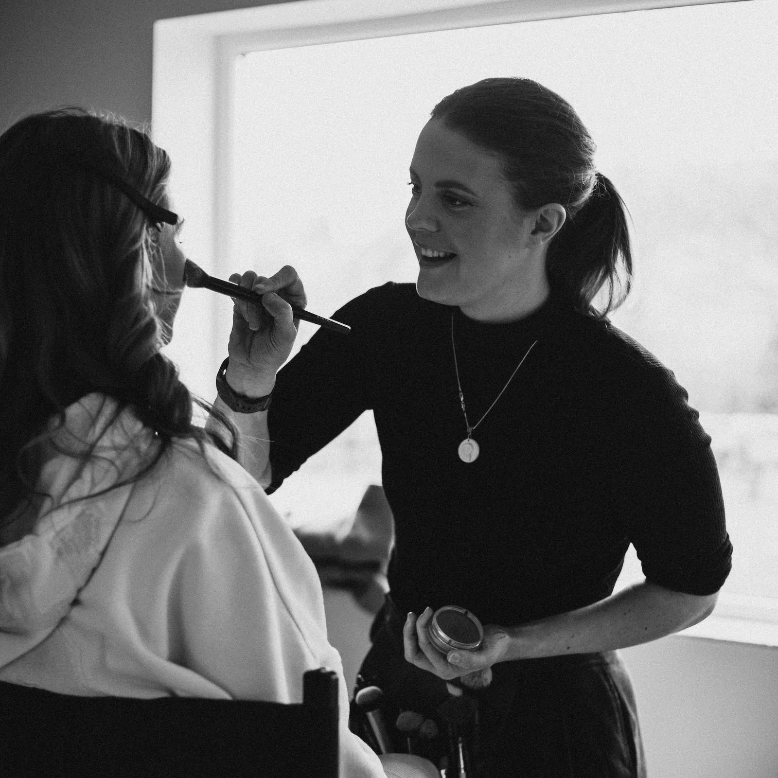 Abi creating a flawless bridal look on a bride