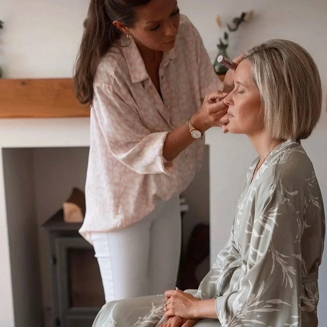 Lady having her wedding makeup done .