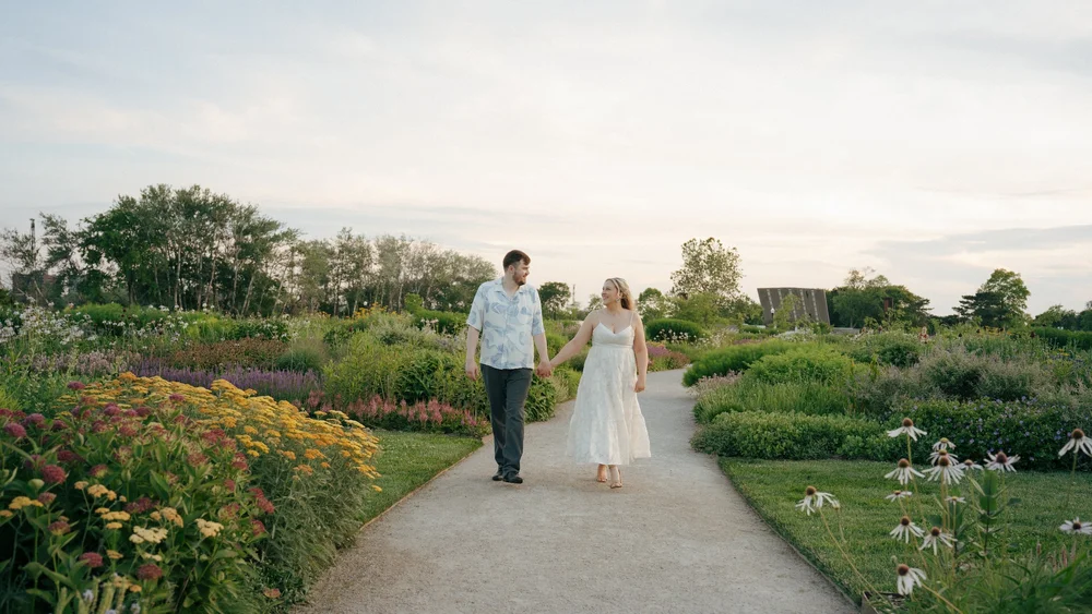 Maggie and Johnathan walking hand in hand through Belle Isle’s flower gardens.
