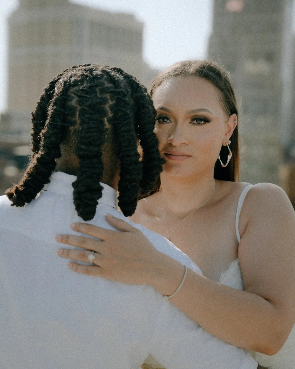 Close view of an embrace during an outdoor wedding.
