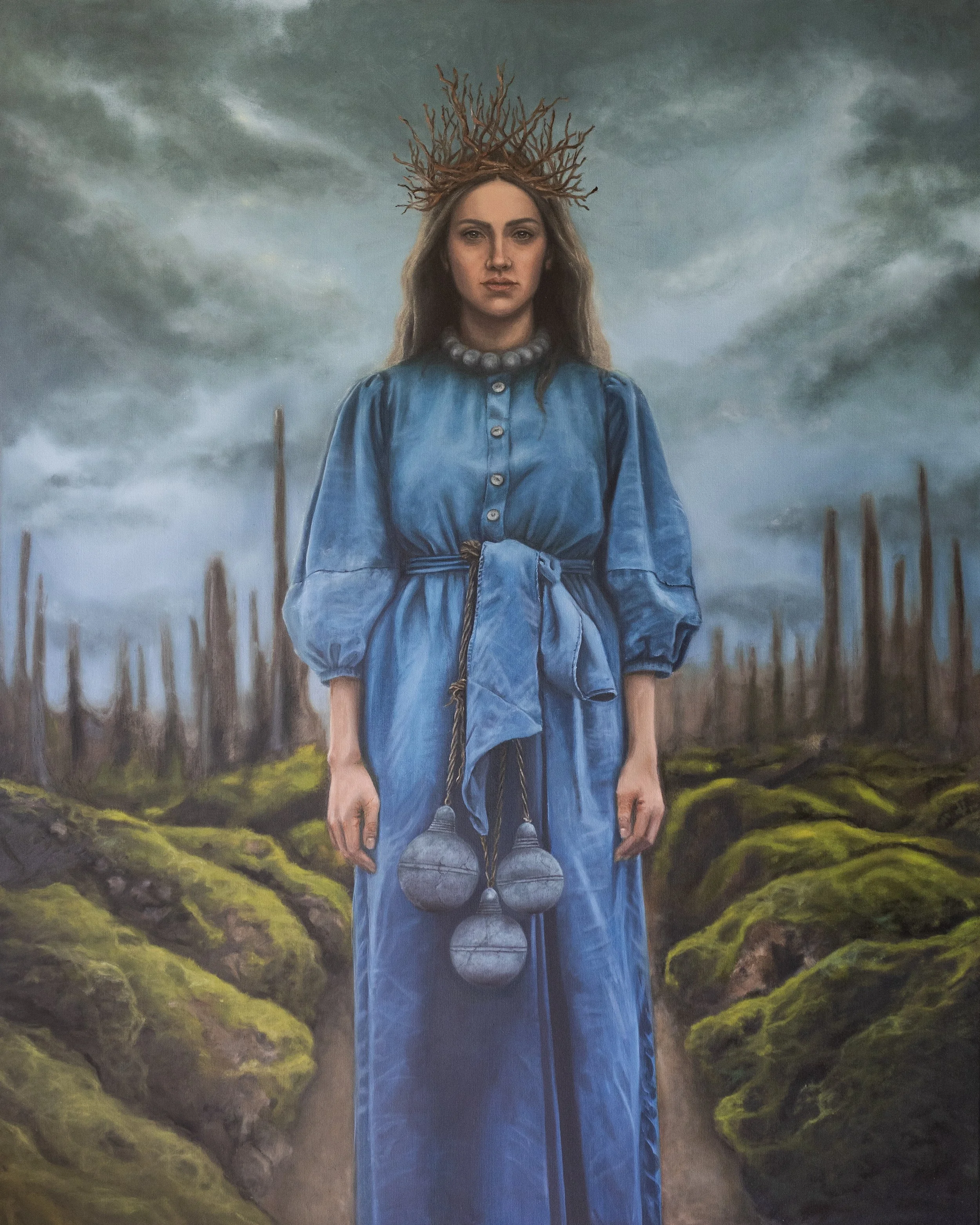 A woman with long brown hair, wearing a blue dress and a pearl necklace, stands in a moss-covered landscape under a cloudy sky. She has a crown made of twigs on her head and is holding a string attached to three gray, spherical objects.
