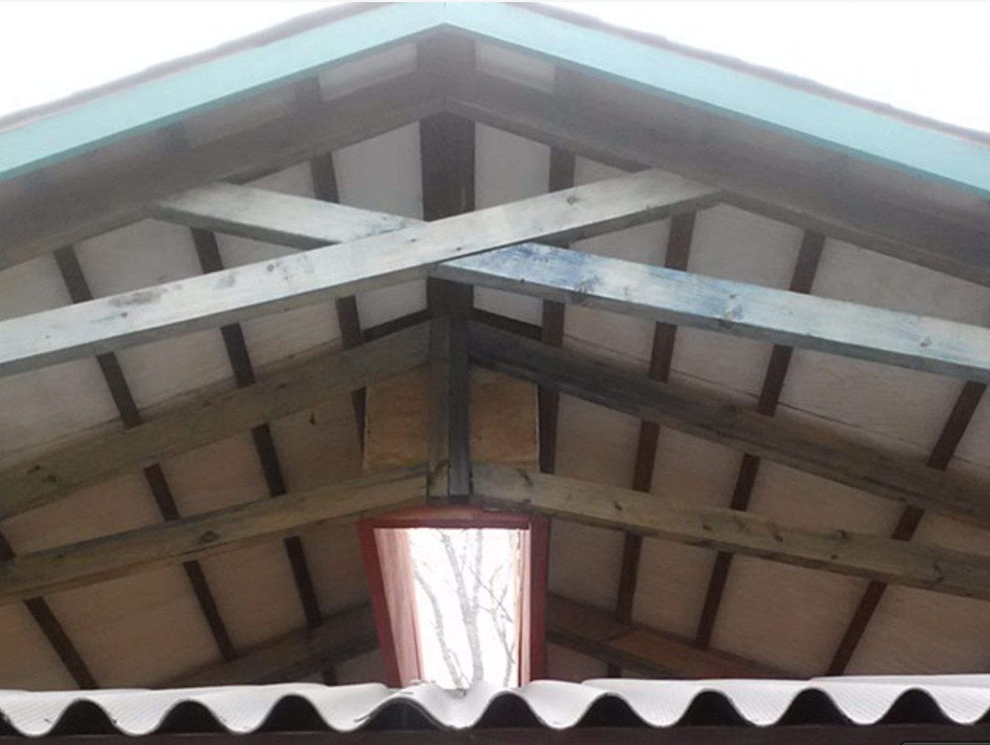 Artist-designed carport by Bill Hochhausen featuring geometric roof structure and handcrafted wood construction.png