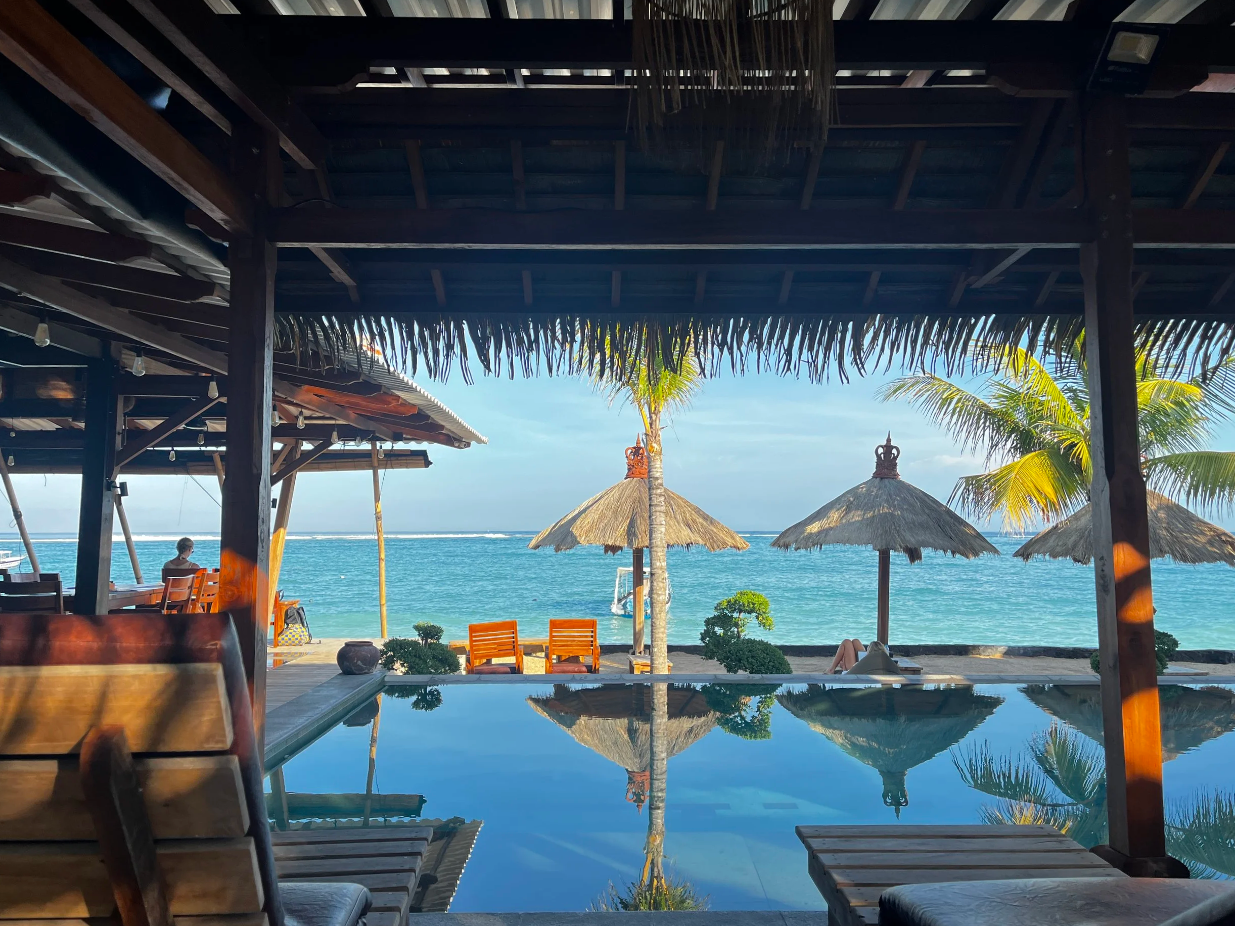 The infinity pool of the hotel and the ocean in the background