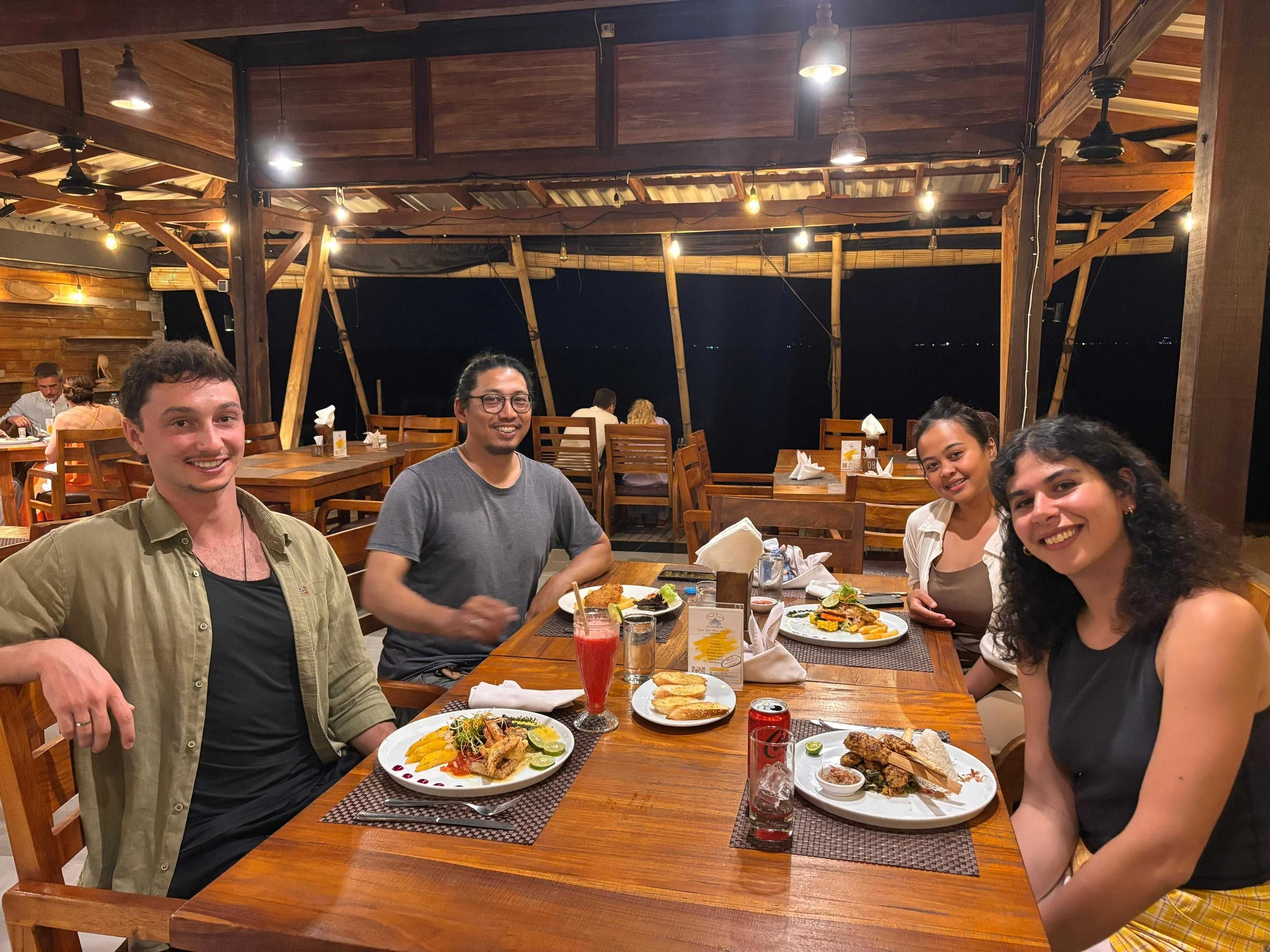 Yudi, Chansa, Nico and Deli having dinner at the hotel and smiling