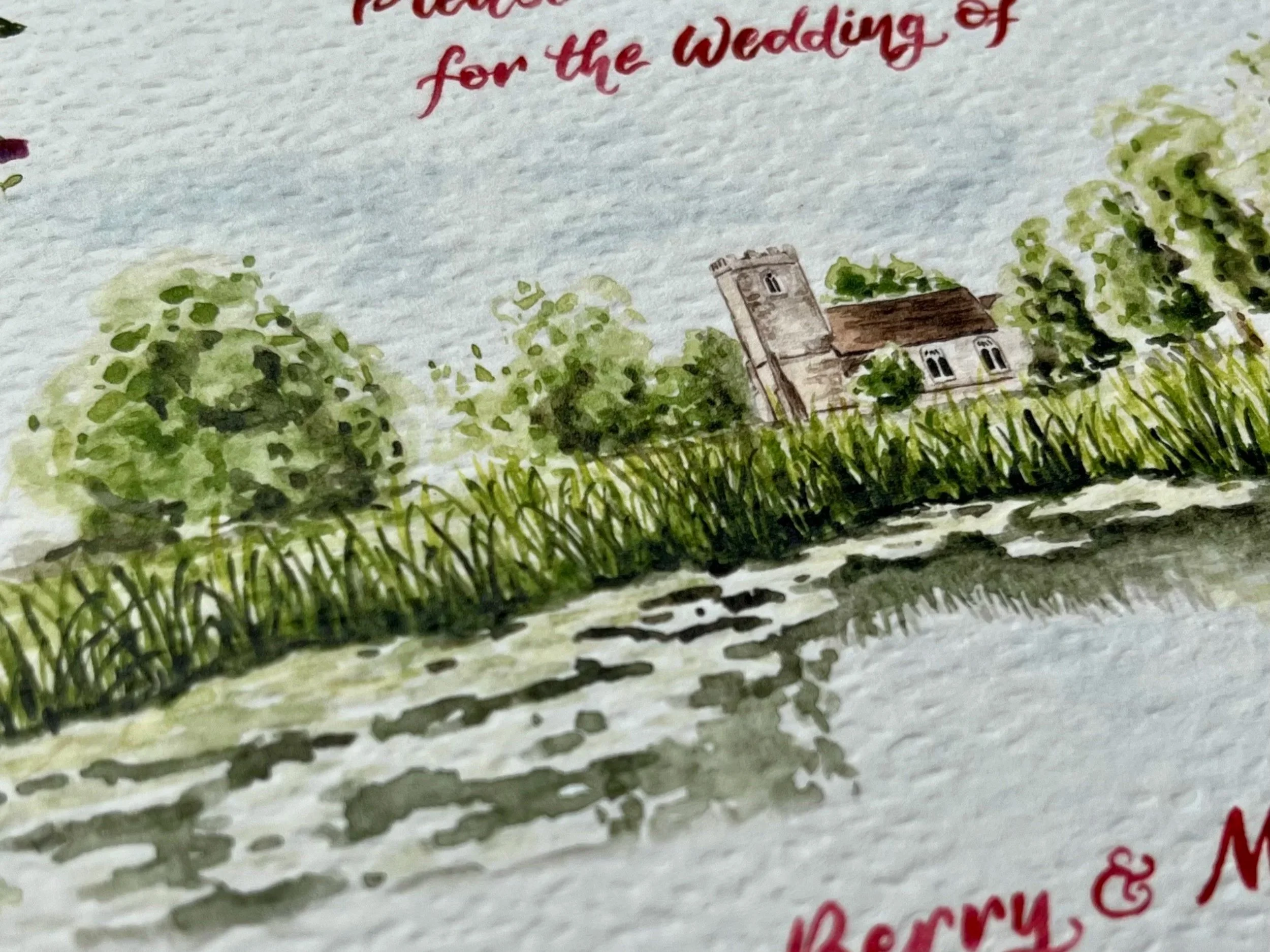 Close-up of a painted illustration featuring trees, a church, and water, with red and pink text above and below.