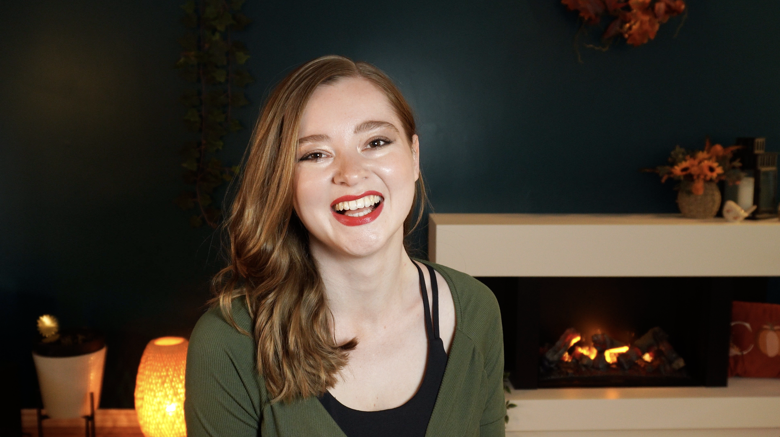 Jenn Scottish Pilates teacher smiling at the camera wearing red lipstick