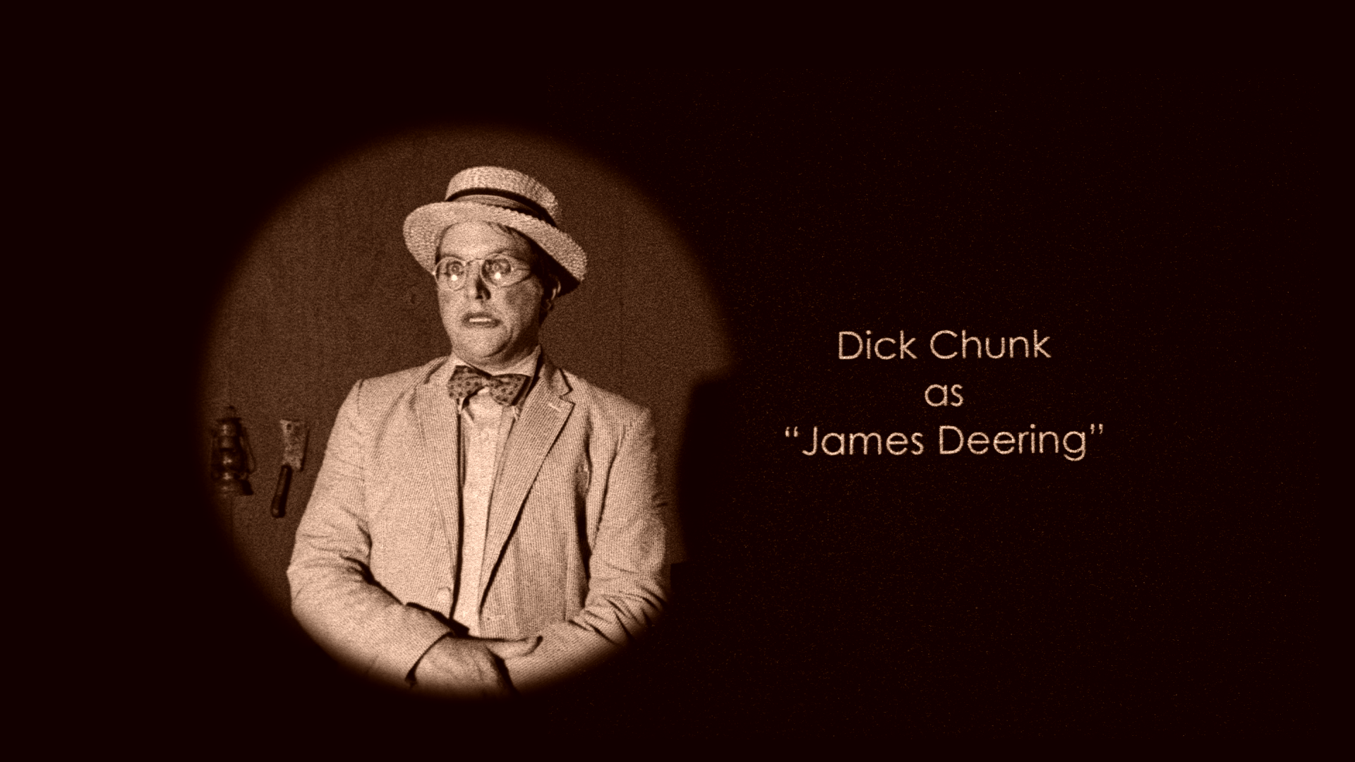 Black-and-white scene of a man wearing a hat, glasses, and a suit, with a surprised expression, standing in front of a wooden wall with tools hanging. Text on the right side reads: "Dick Chunk as 'James Deering'".