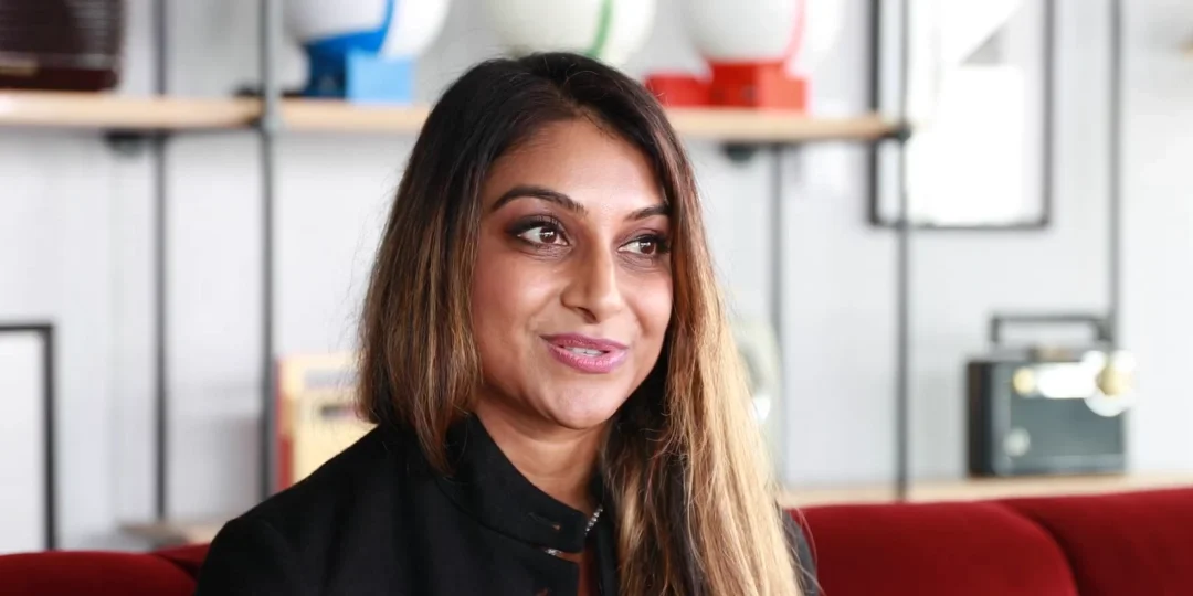 A lady in her office desk being interviewed