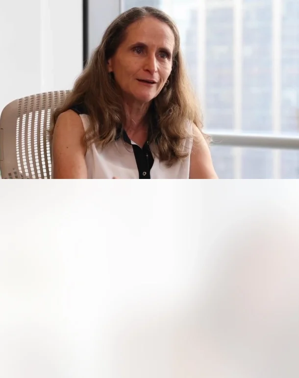 A lady in her office desk being interviewed