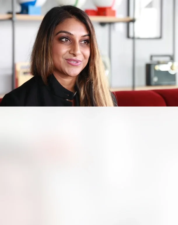 A lady in her office desk being interviewed