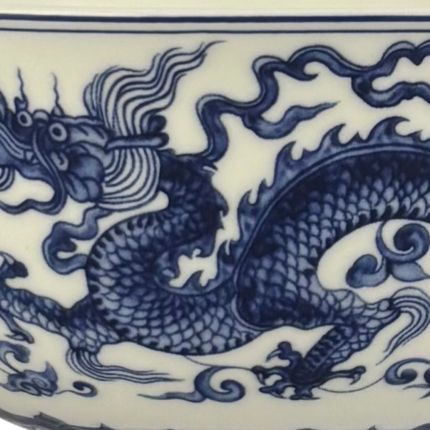 Close-up of a blue and white ceramic plate or vase featuring a detailed dragon design.