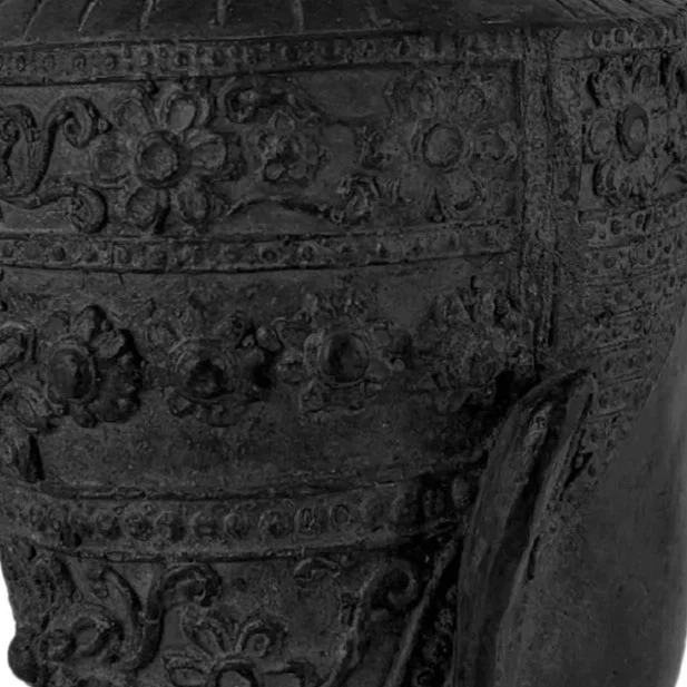 Close-up of an ornate, historical metal artifact with detailed engravings and decorative patterns.