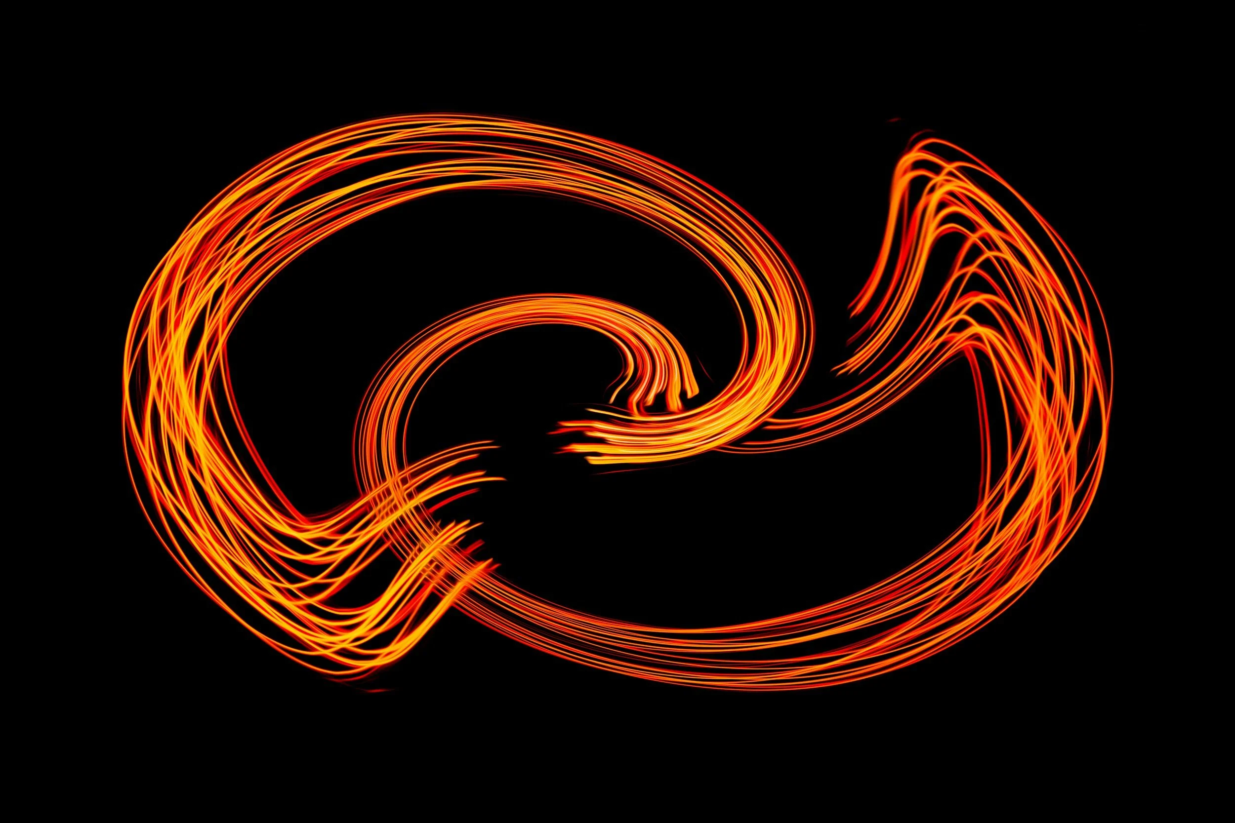 Abstract fiery lines forming a flaming infinity symbol on a black background
