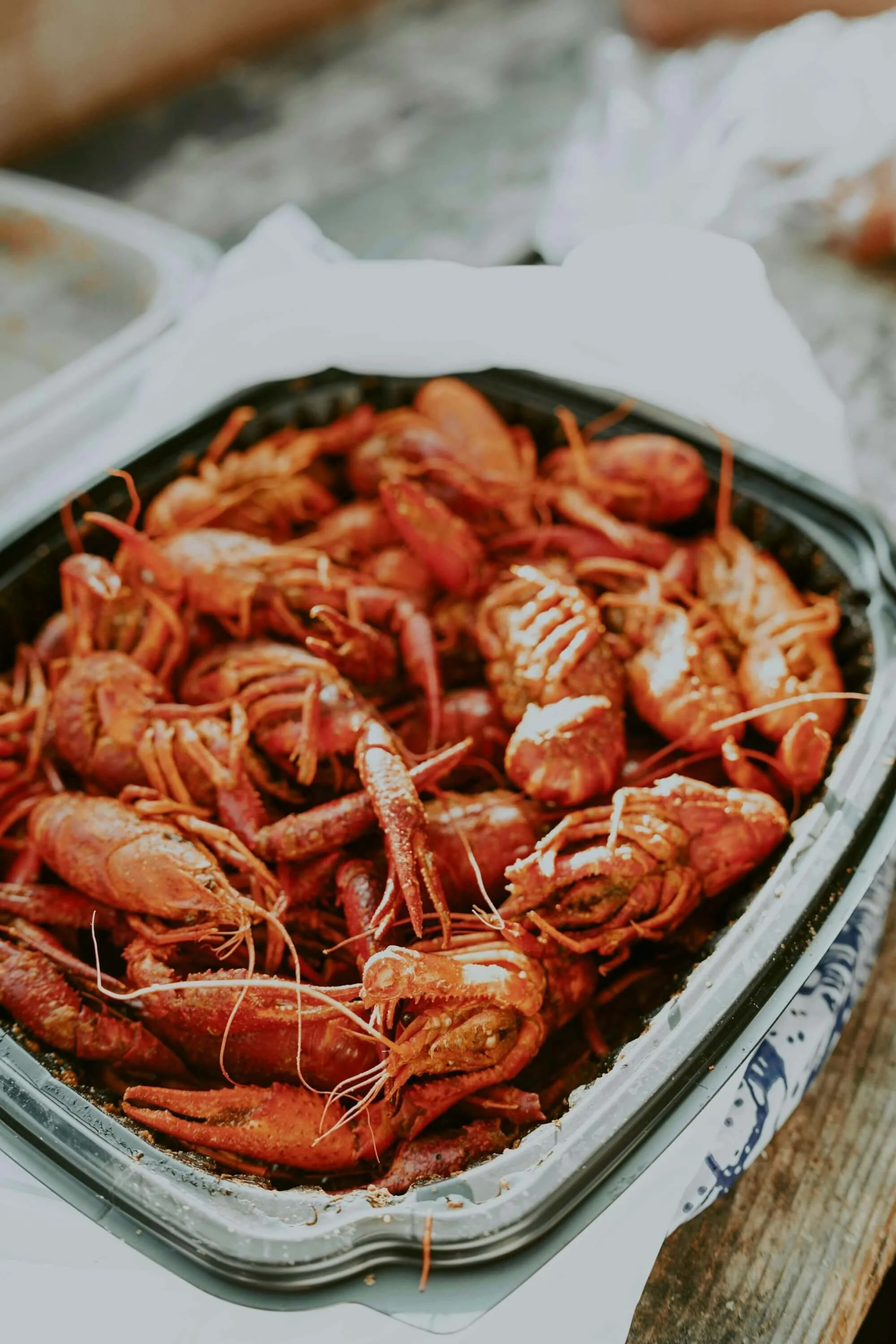 Tray of bright red boiled crawfish seasoned with spices, served Louisiana-style and ready to eat.