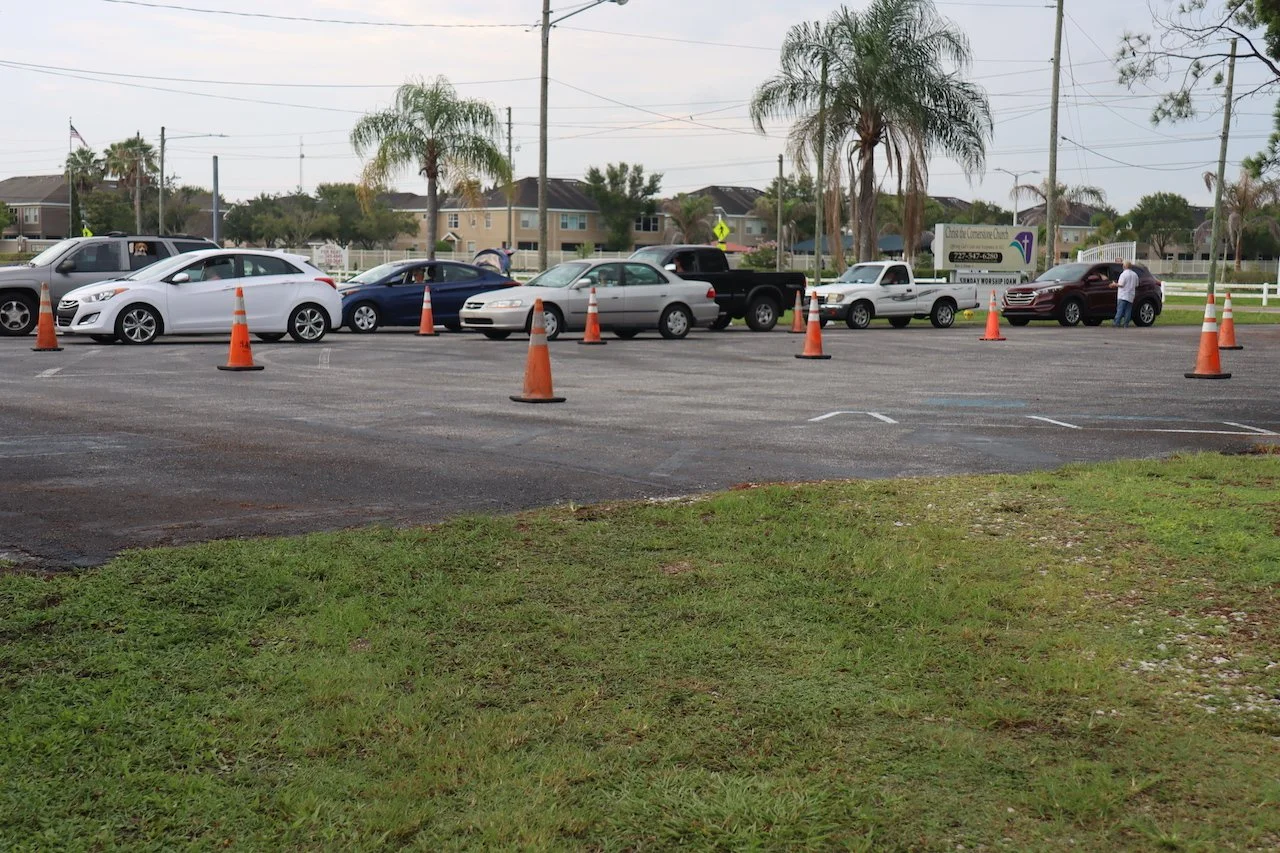 cars lined up in the church parking lot waiting for the food pantry to start.