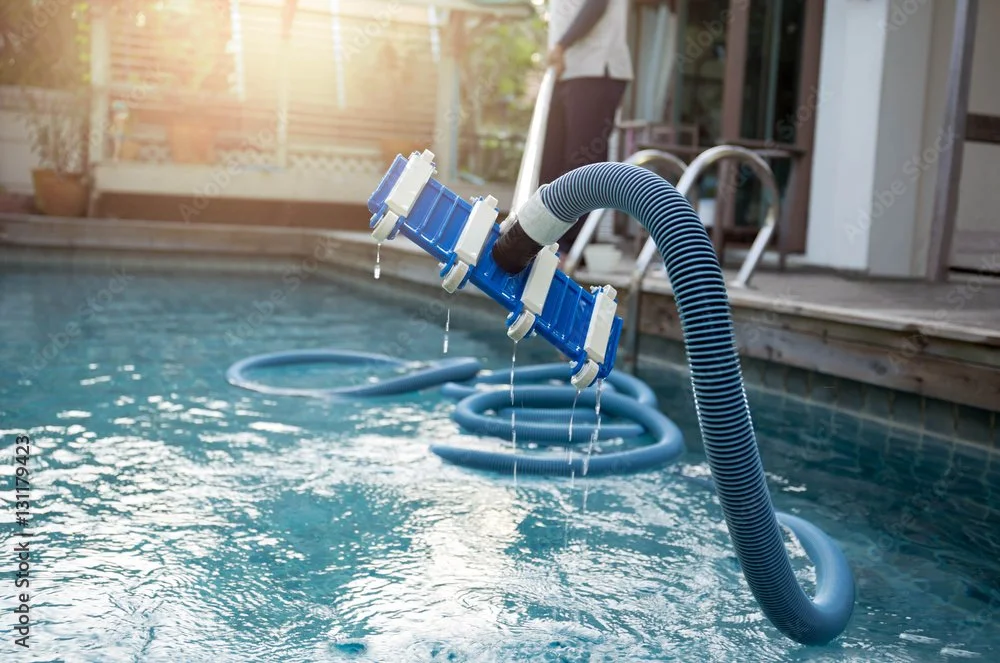 Pool cleaning equipment in use during routine pool maintenance, similar to the service Tejas Hills Pool and Spa provides in the Lake Travis and Lakeway area.