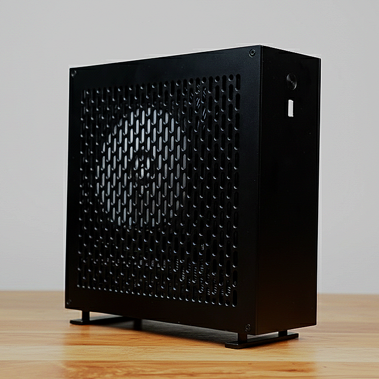 Black computer case with a side ventilation panel and a visible fan, placed on a wooden surface.
