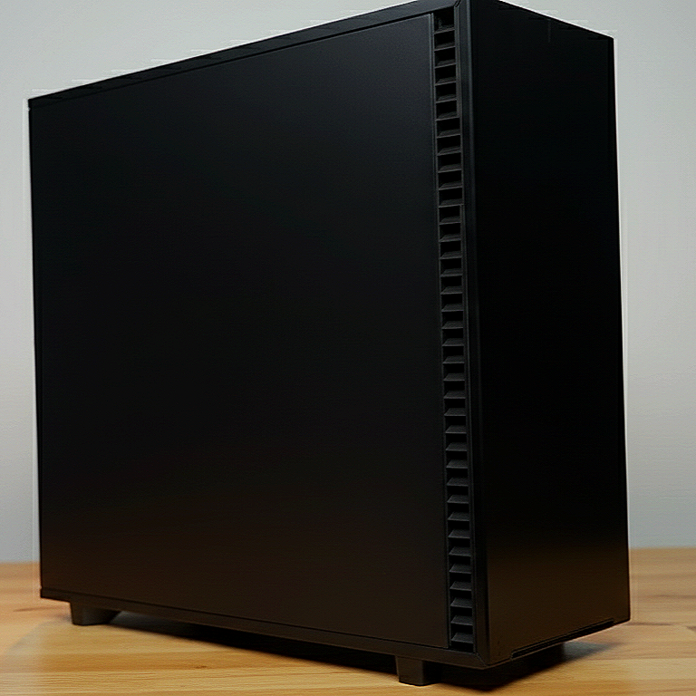 A black computer tower case on a wooden desk.