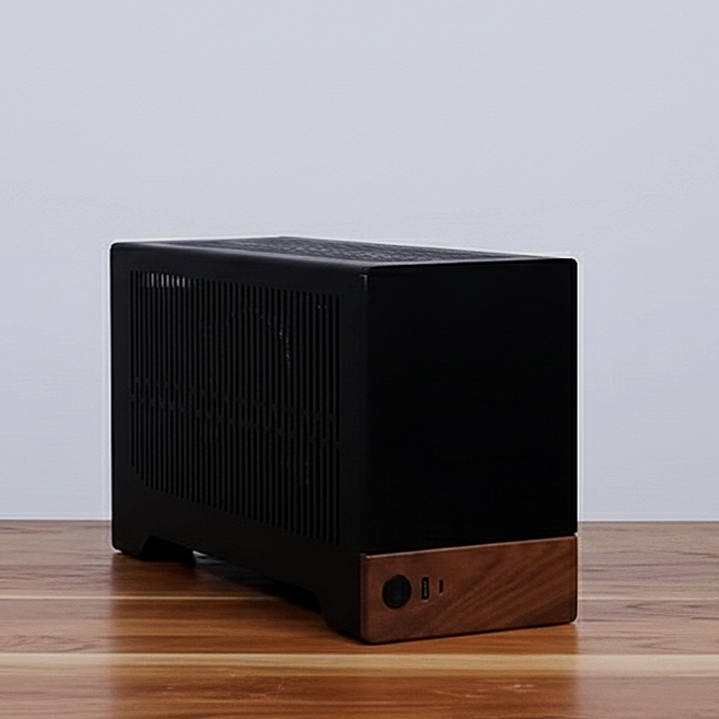 A black desktop computer case with a wooden front panel on a wooden floor against a plain white wall.