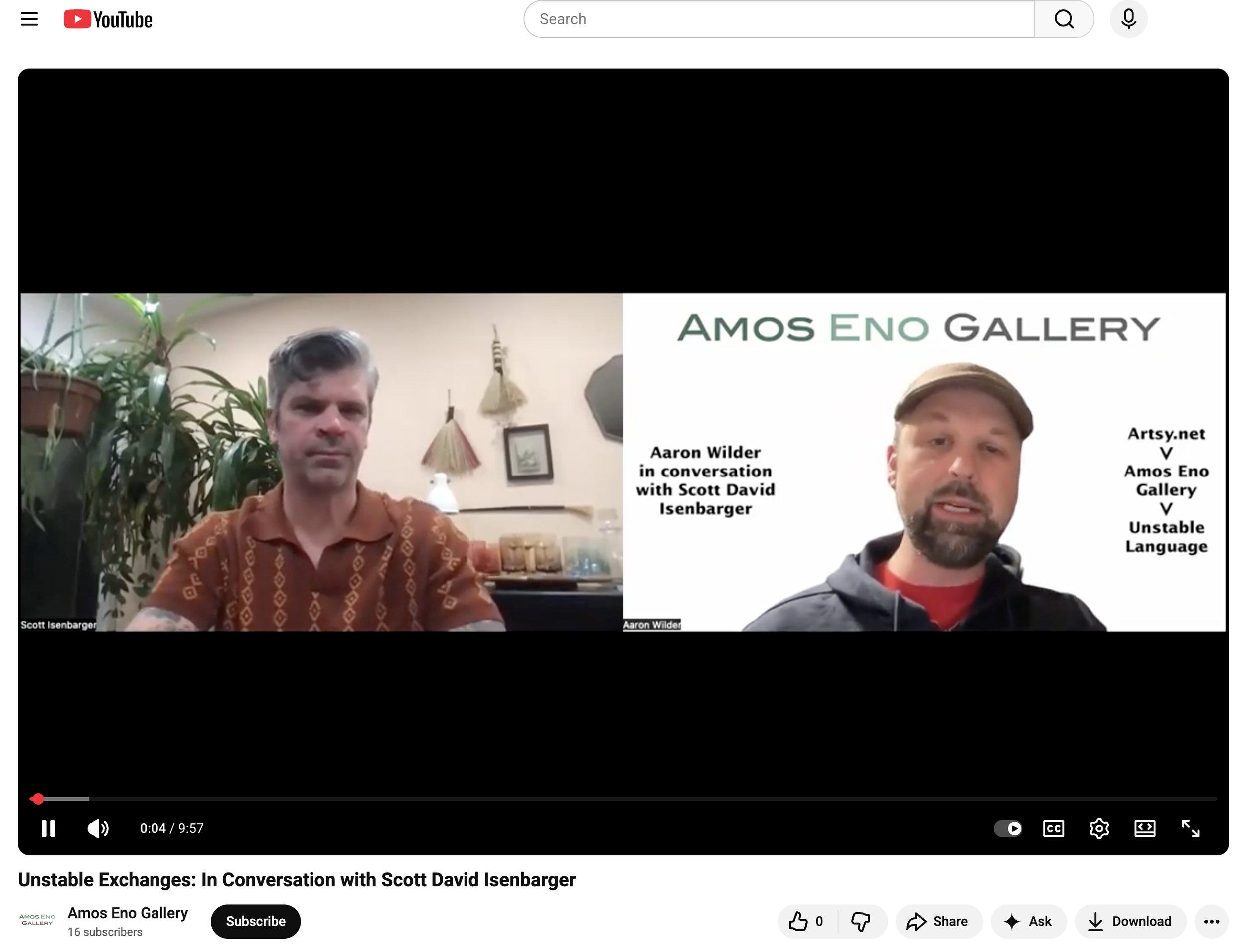 Screenshot of a YouTube video titled "Unstable Exchanges: In Conversation with Scott David Isenbarger" featuring two men. The man on the left has gray hair and is wearing a brown patterned shirt, and the man on the right has a beard, cap, and is wear