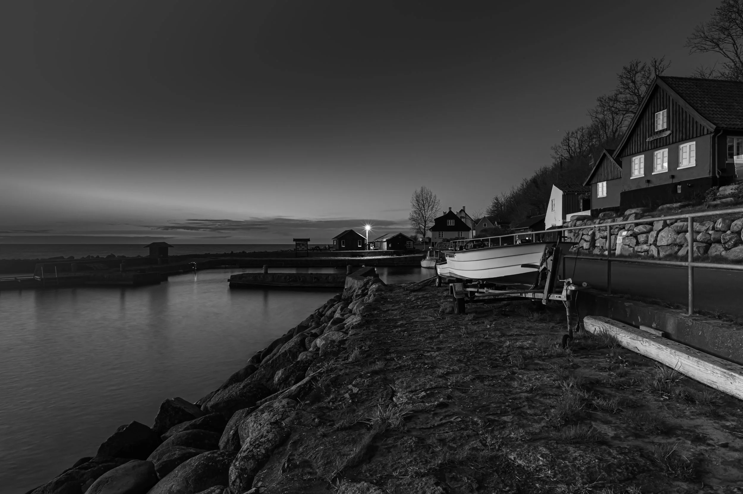 small fishing port at night in black and white bornholm