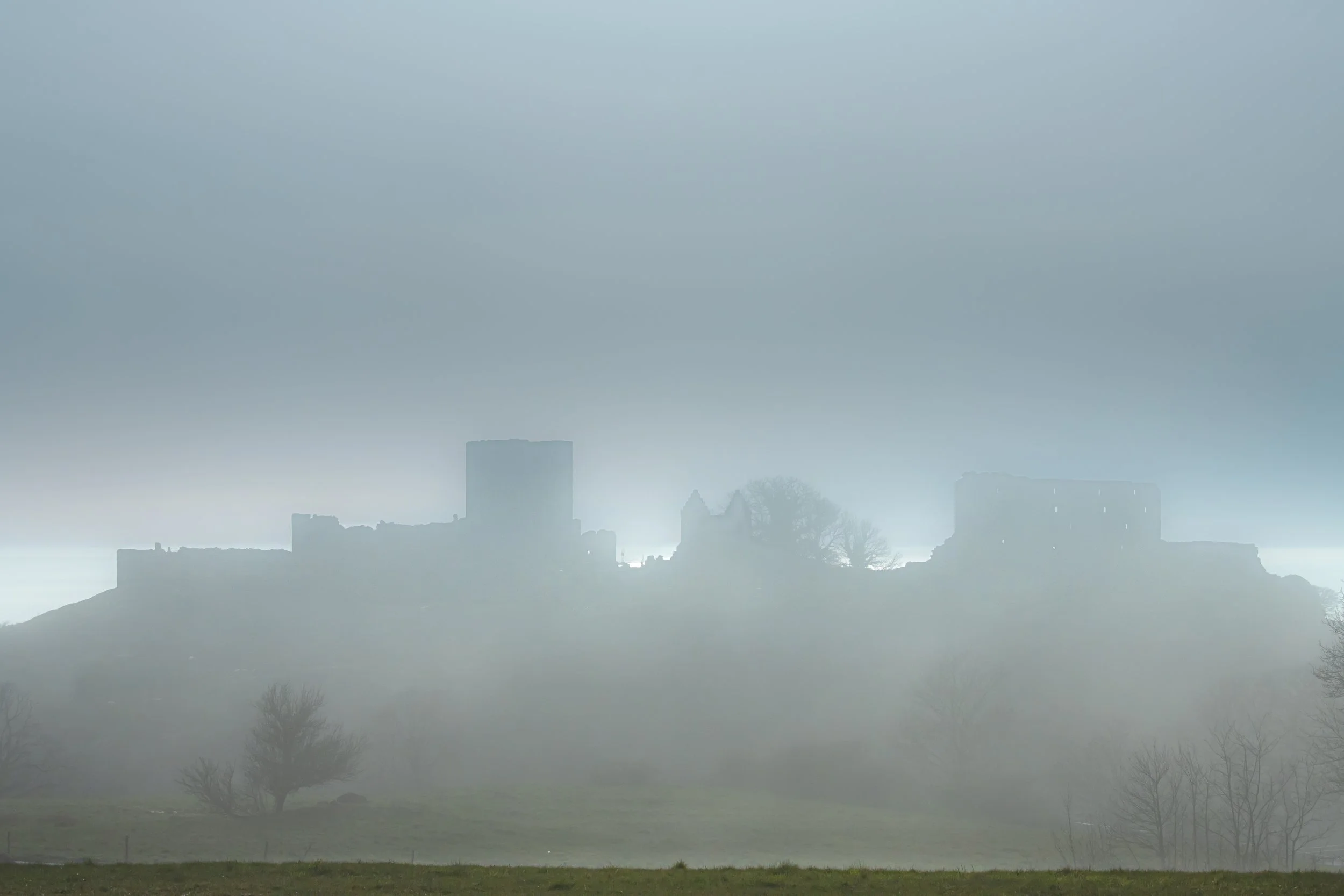 Castle ruins in evening mist