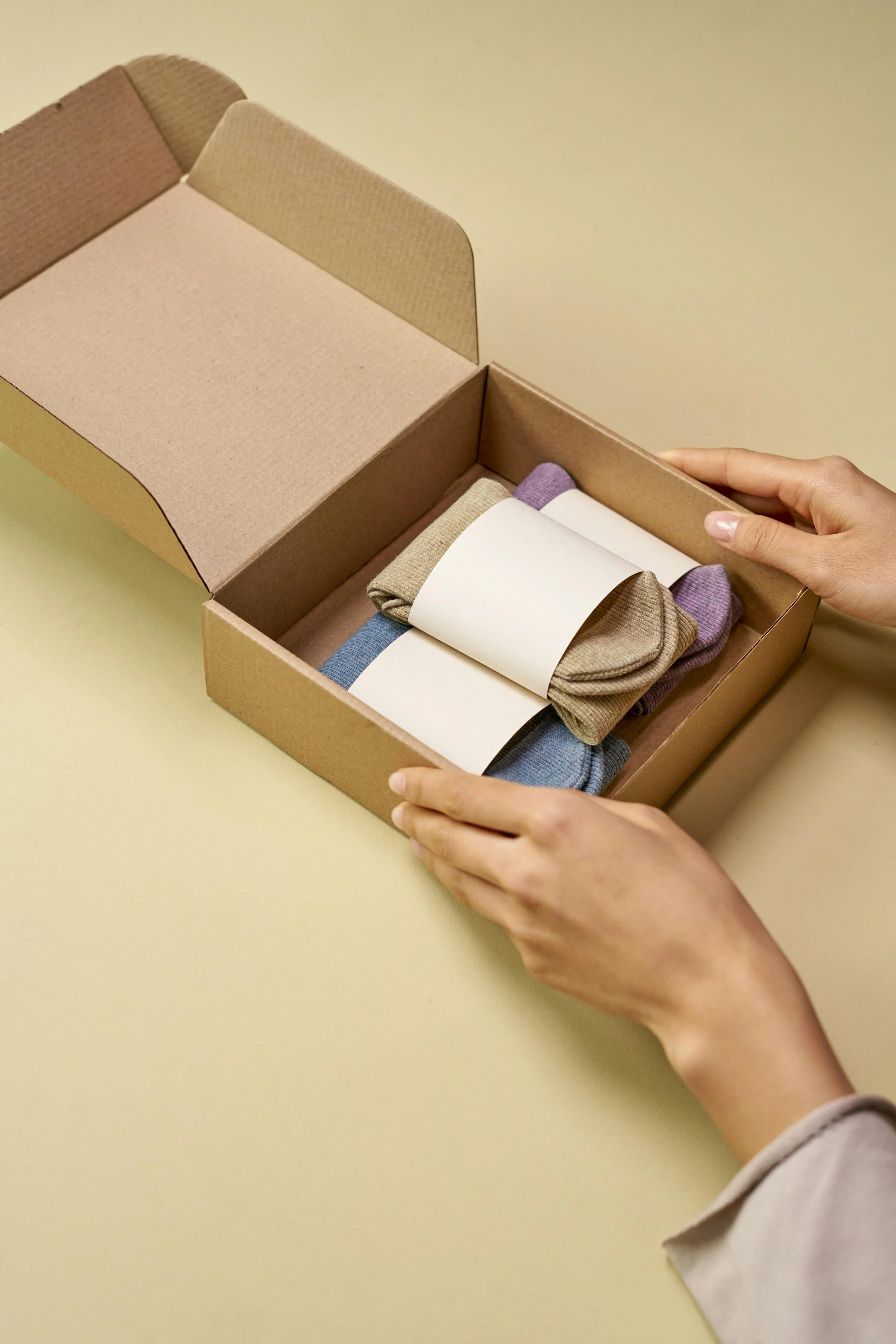 Fashion E-commerce retail products in sustainable cardboard packaging box with tissue paper