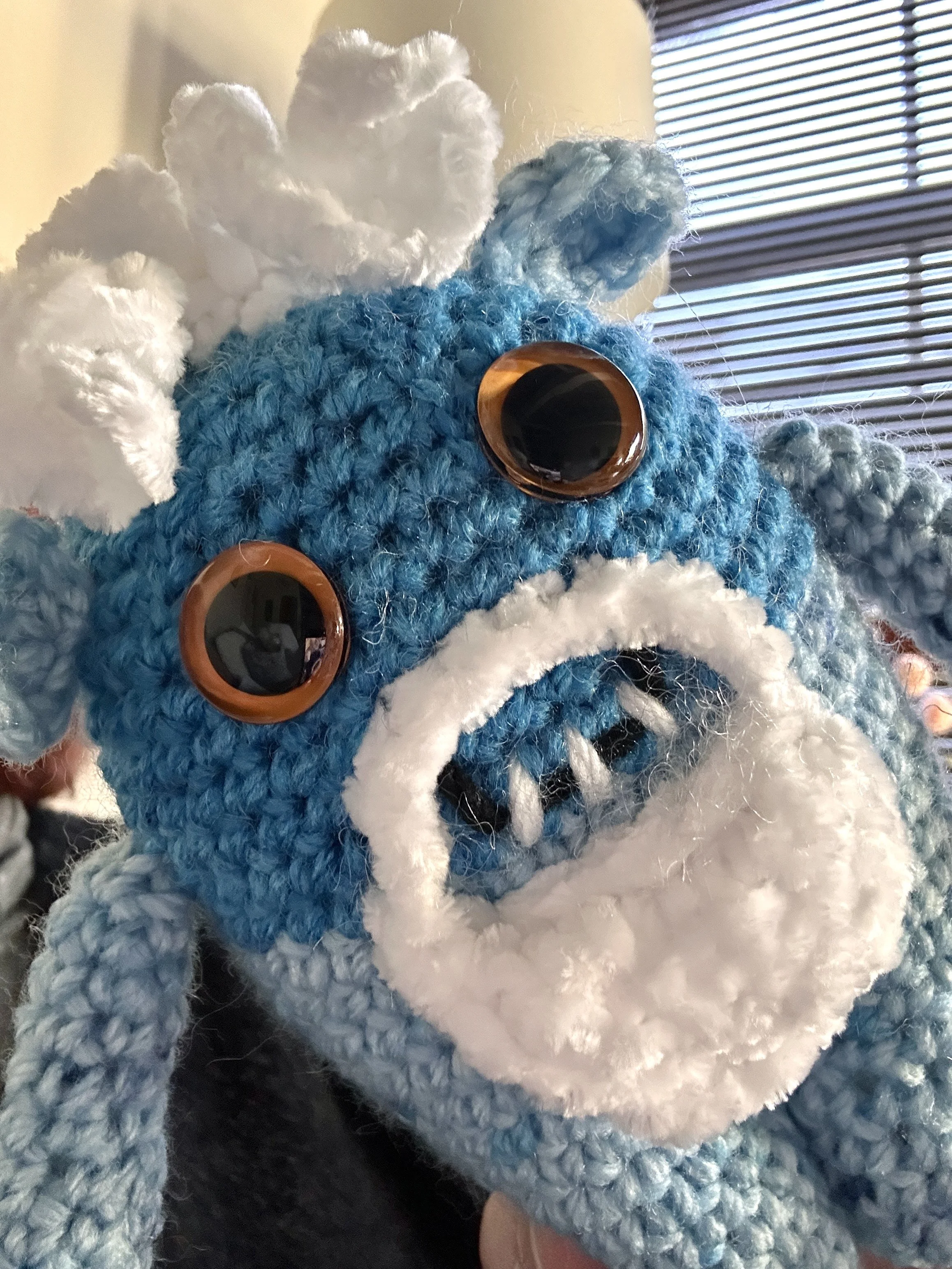 Snowbeard shades of blue white hair white beard orange googly eyes smiling with 3 teeth