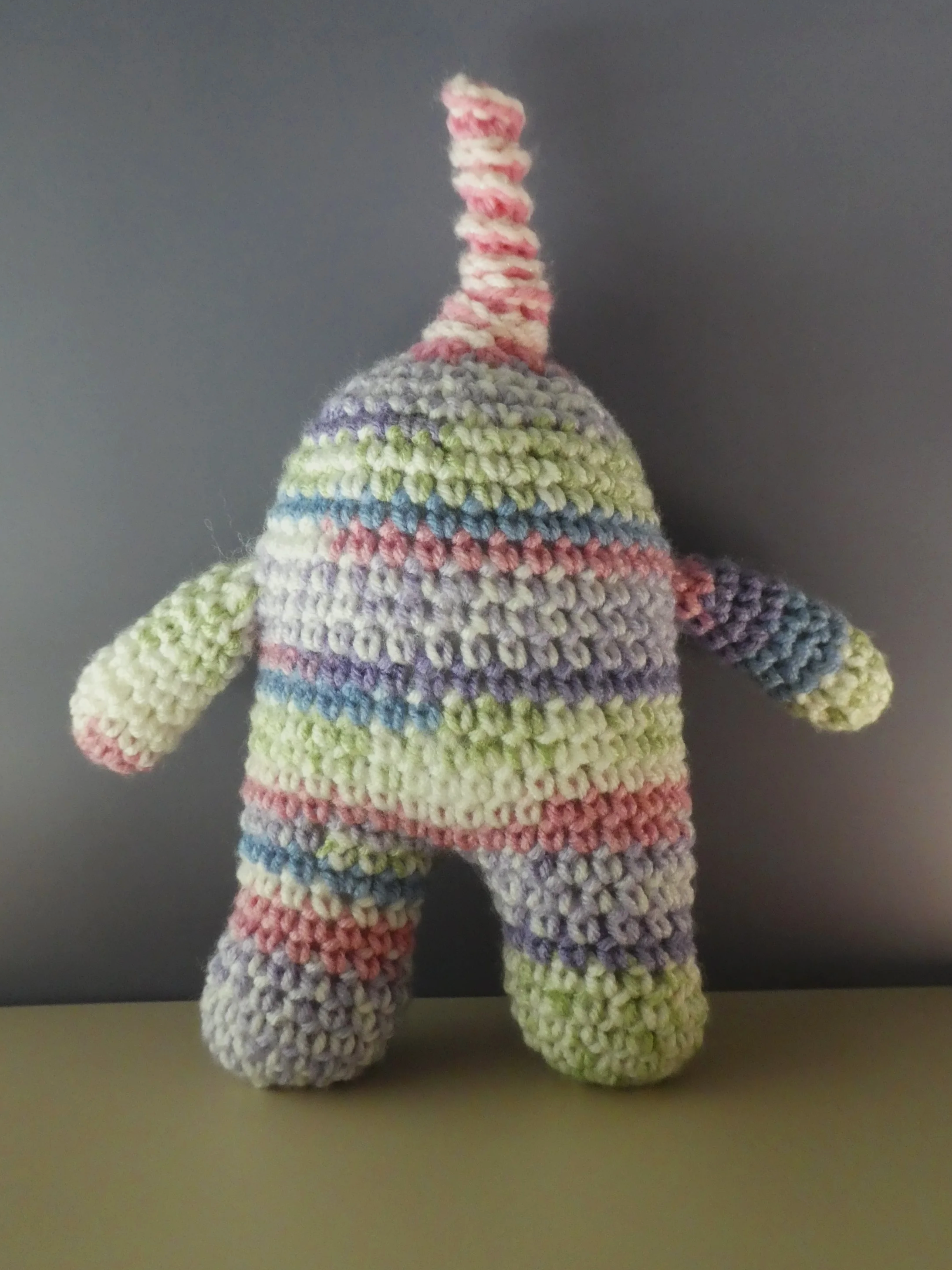 Quark back of light purple pink and white striped monster with pink and white spiral horn