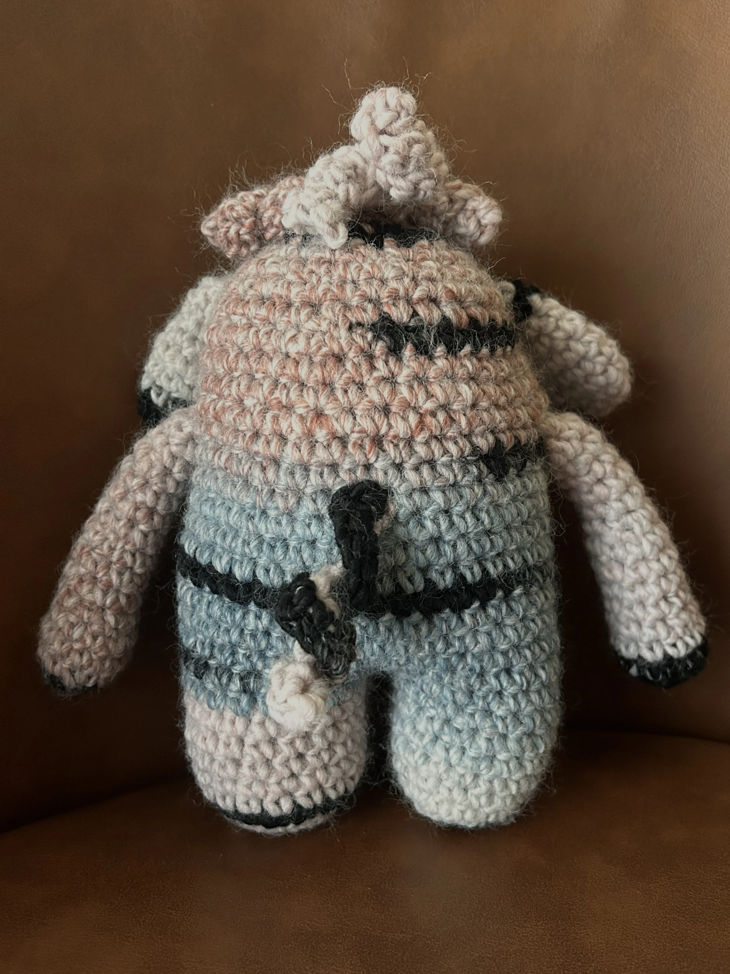 Dusty back of light pink blue black monster with curly black tail