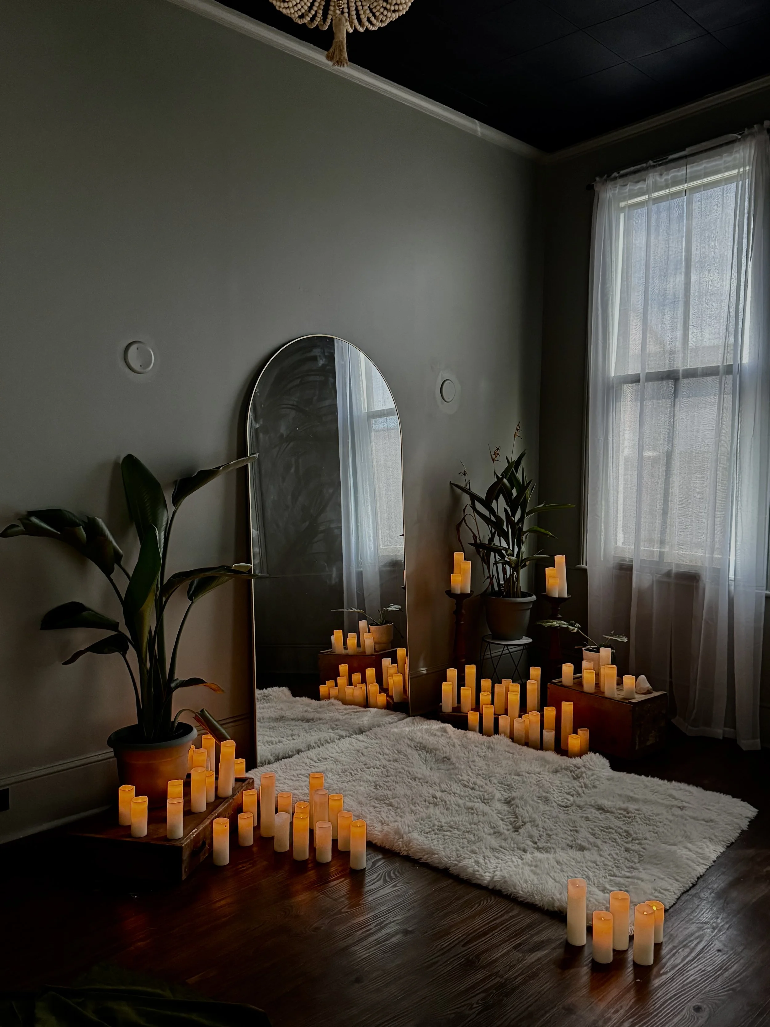 Warm candlelight boudoir set with botanical greenery and tropical plants, intimate fine art photography, Bay Street Studios, South Carolina