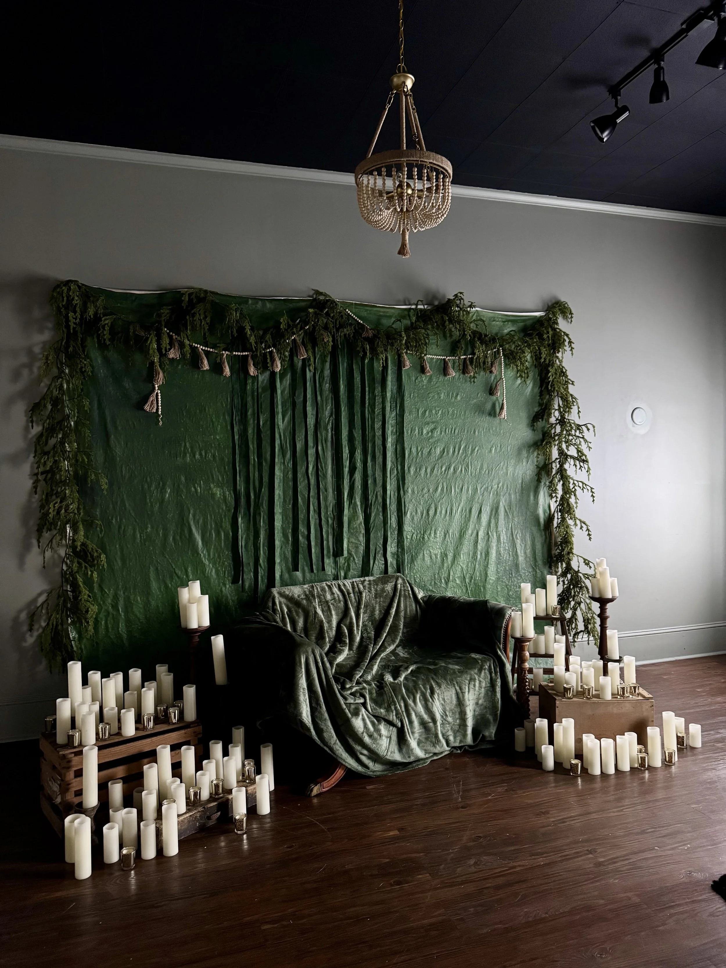 Lush botanical green velvet backdrop with hanging greenery and candles, intimate boudoir set at Bay Street Studios, Beaufort SC