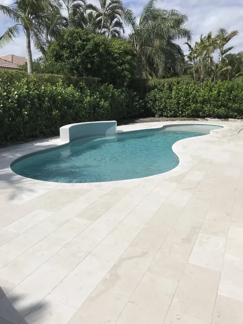 White marble paver pool deck in Palm Beach Gardens, FL