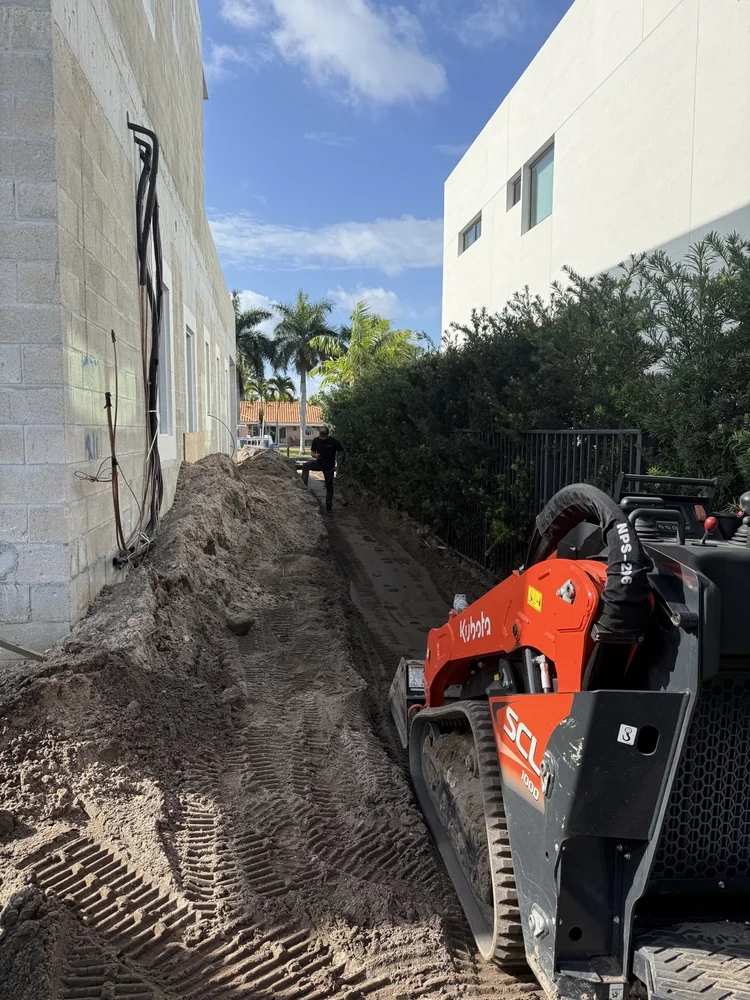 Trench being dug alongside a house