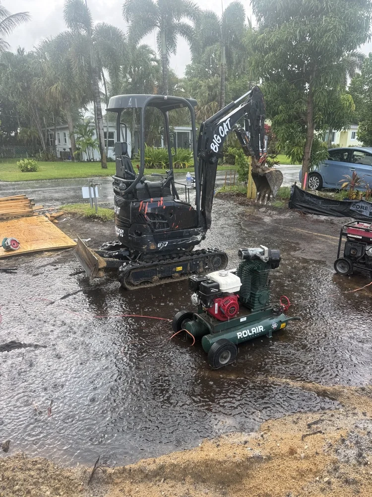 Mini excavator placing fill on a jobsite