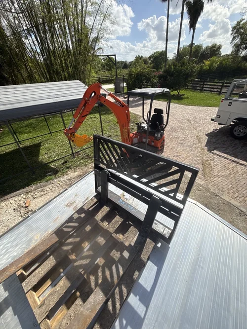 Excavator and trailer on site