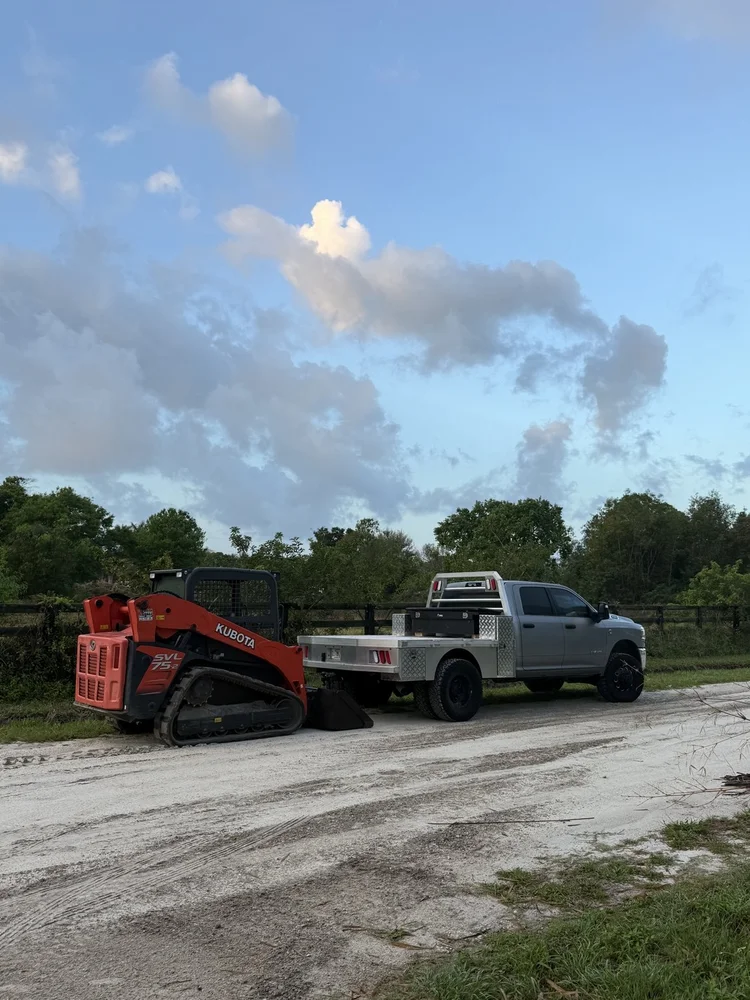 Big Cat Hardscapes truck and equipment on a cleared site