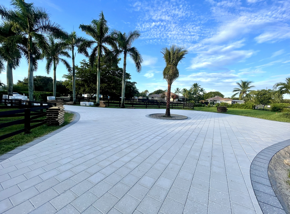 Large paver motor court with palm trees installed by Big Cat Hardscapes in West Palm Beach, FL