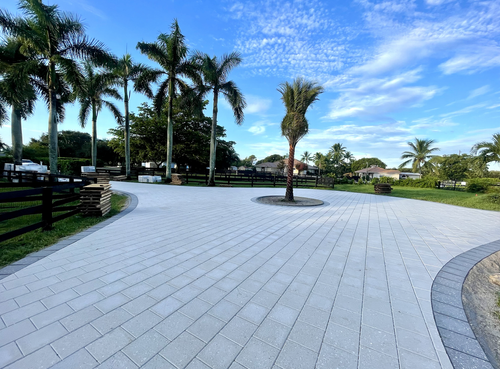 Large paver motor court with palm trees installed by Big Cat Hardscapes in Palm Beach Gardens, FL