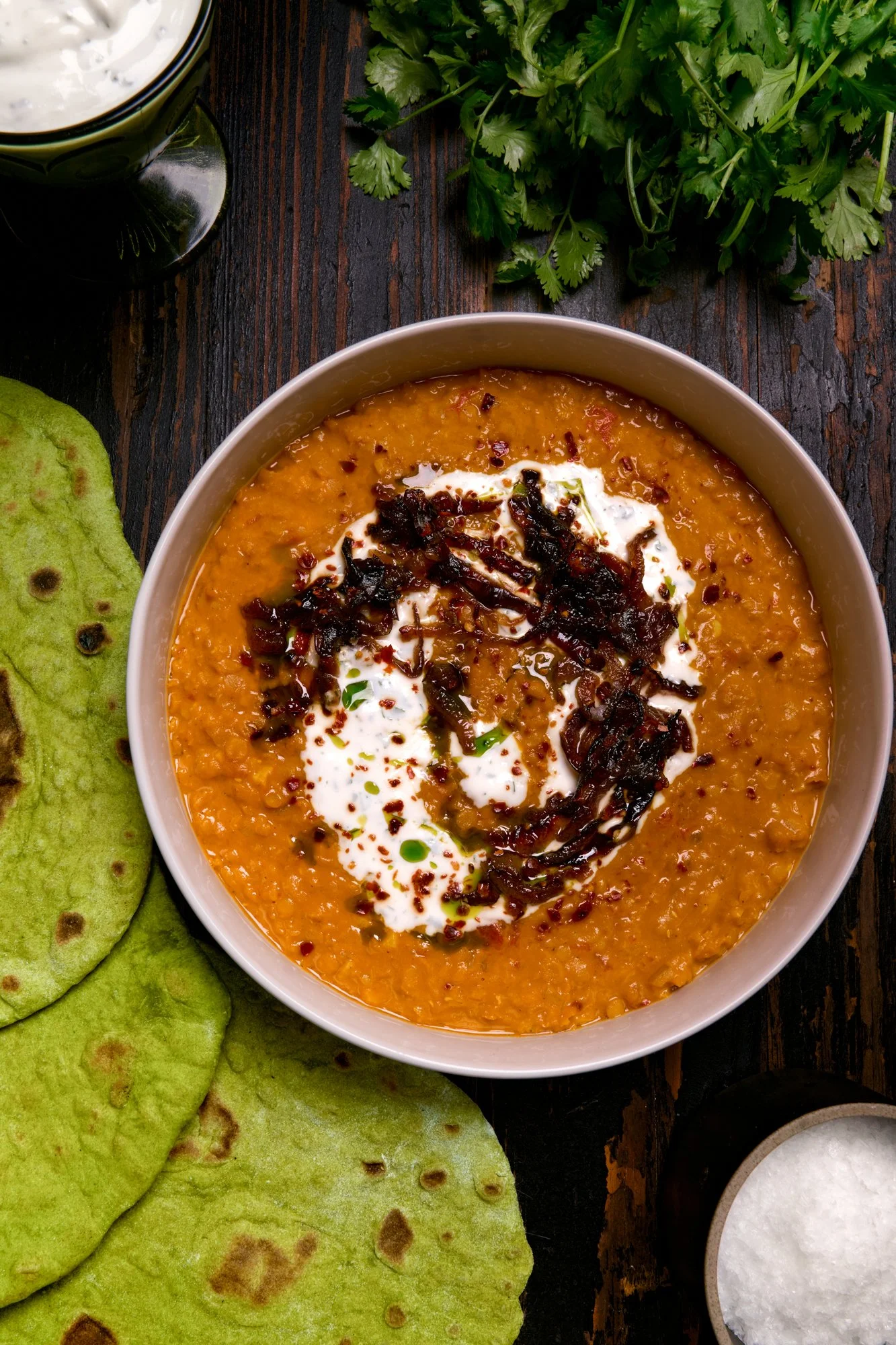 red daal with sticky onions, garlic yogurt, and cilantro oil served with green spinach flatbreads